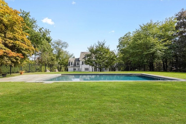 view of swimming pool featuring a yard and fence