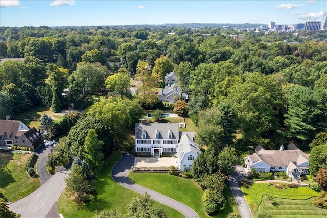 bird's eye view with a wooded view