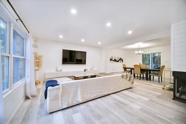 living room with a chandelier and light hardwood / wood-style flooring