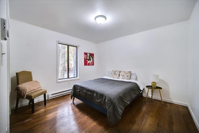 bedroom with dark hardwood / wood-style flooring and a baseboard heating unit