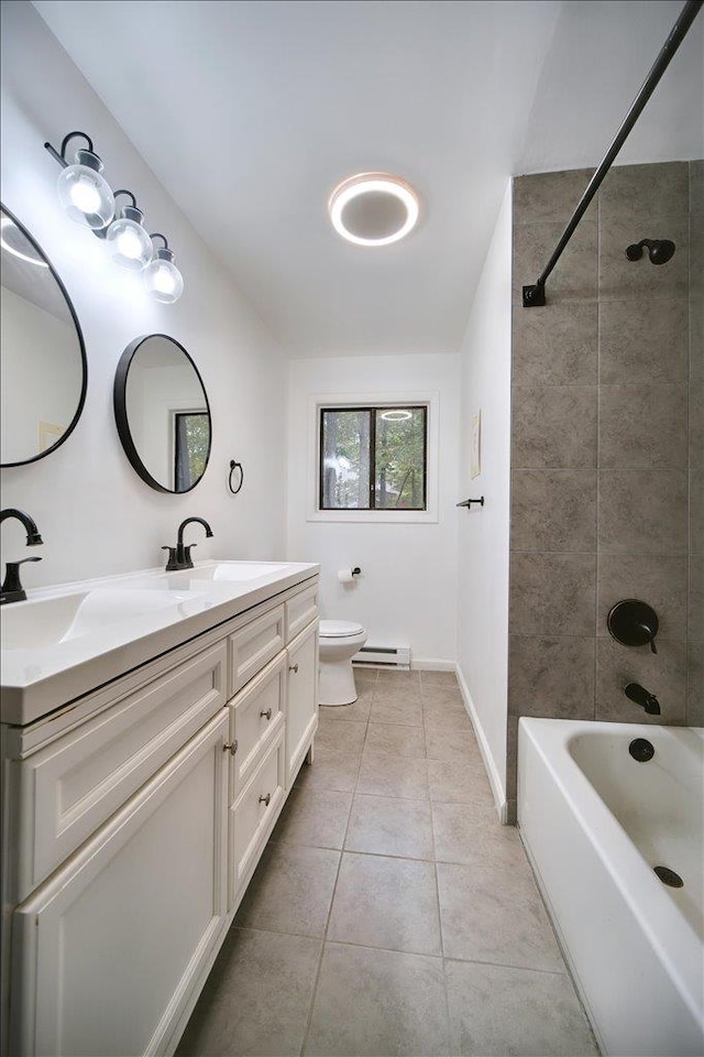 full bathroom featuring tile patterned floors, vanity, a baseboard radiator, toilet, and tiled shower / bath