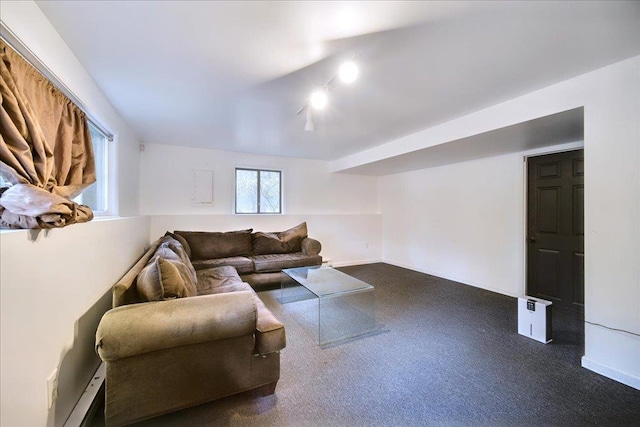 living room with dark carpet and a baseboard heating unit