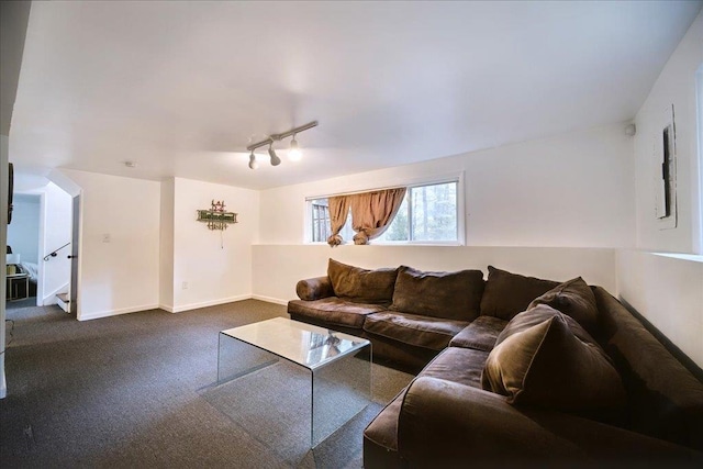 living room with dark colored carpet and rail lighting