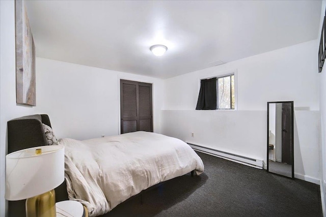 carpeted bedroom with a baseboard heating unit