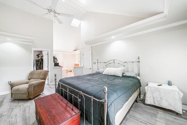 bedroom featuring ceiling fan, a spacious closet, hardwood / wood-style floors, vaulted ceiling, and a closet