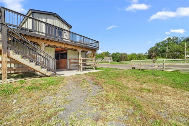 view of yard featuring a rural view and a deck