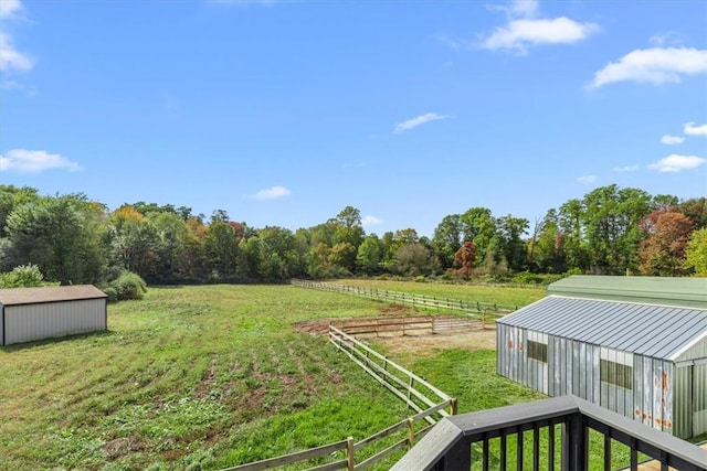 view of yard with a rural view and an outdoor structure