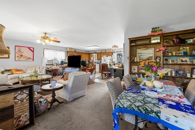 carpeted dining room featuring ceiling fan