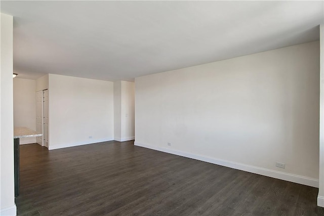 empty room with dark hardwood / wood-style floors