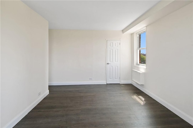 empty room featuring dark wood-type flooring