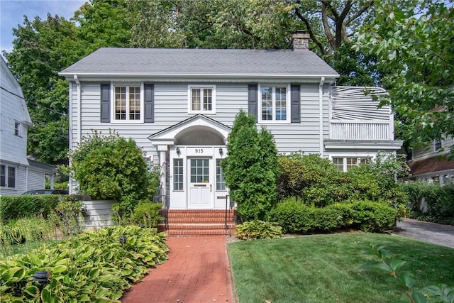 colonial home with a front yard