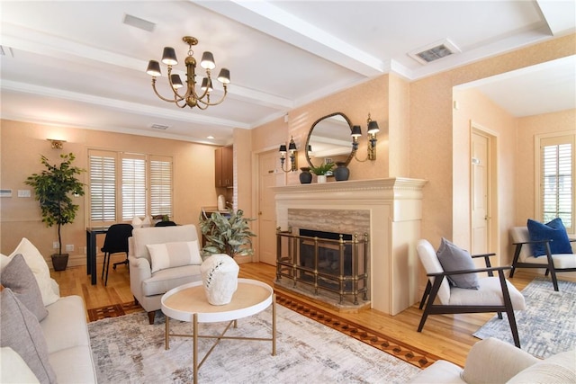 living room featuring light wood-type flooring, a wealth of natural light, and a premium fireplace