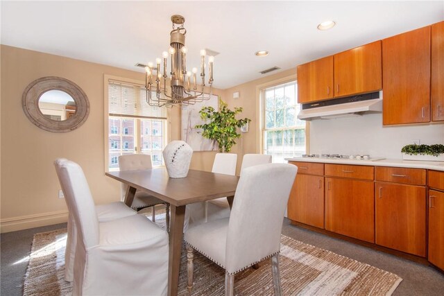 carpeted dining space with a notable chandelier