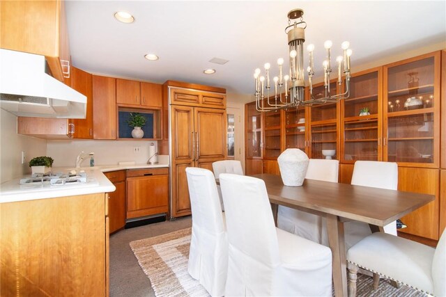 carpeted dining space with a chandelier