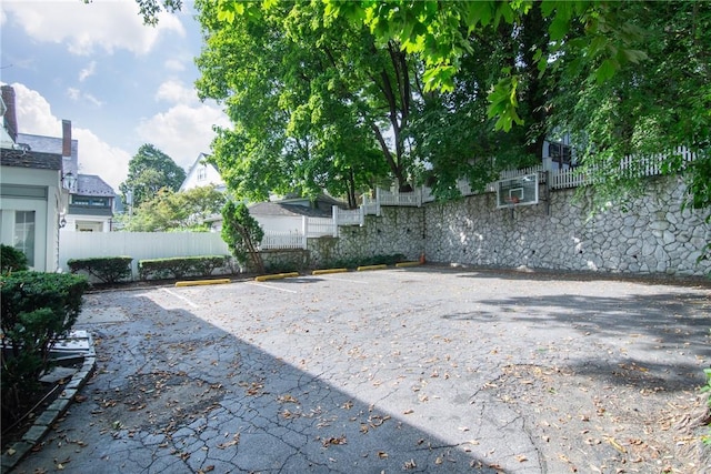 view of patio featuring basketball hoop