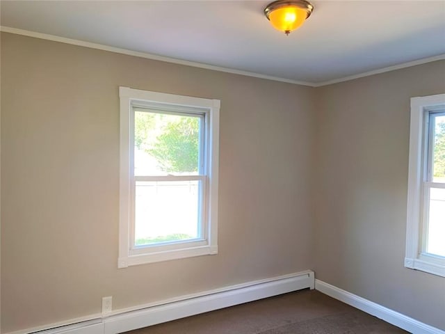 spare room with ornamental molding and a baseboard heating unit