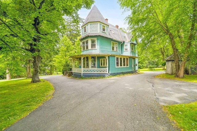 victorian house with covered porch and a front yard