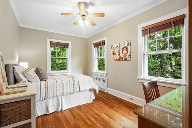 105 Walworth Ave, Scarsdale, NY 10583 - bedroom featuring radiator heating unit, baseboards, wood finished floors, ornamental molding, and a ceiling fan