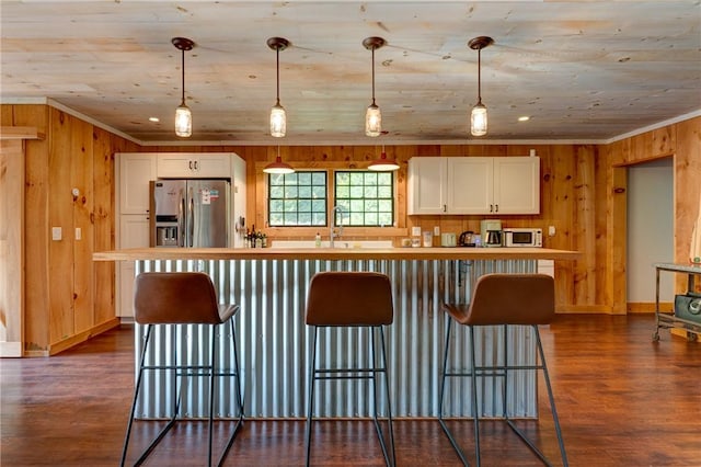 kitchen with pendant lighting, white cabinetry, stainless steel appliances, and dark wood-type flooring