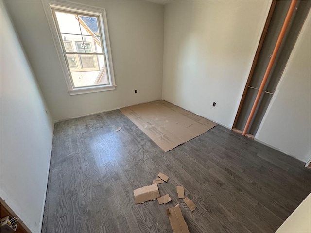 empty room with dark hardwood / wood-style flooring