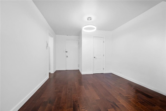 corridor with dark hardwood / wood-style floors