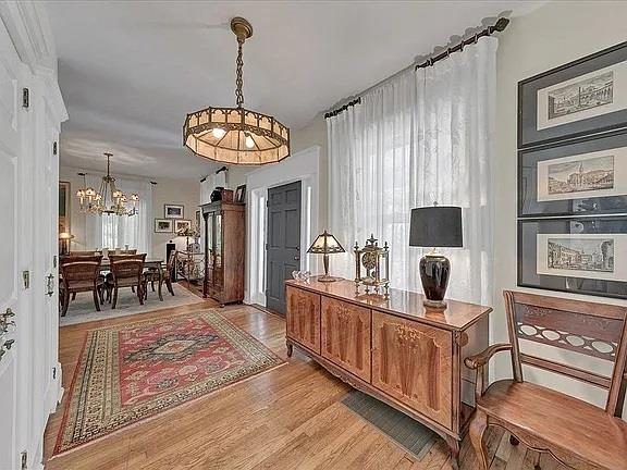 office space with light wood-type flooring and an inviting chandelier