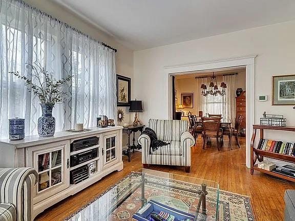 living room featuring a wealth of natural light, hardwood / wood-style floors, and a chandelier