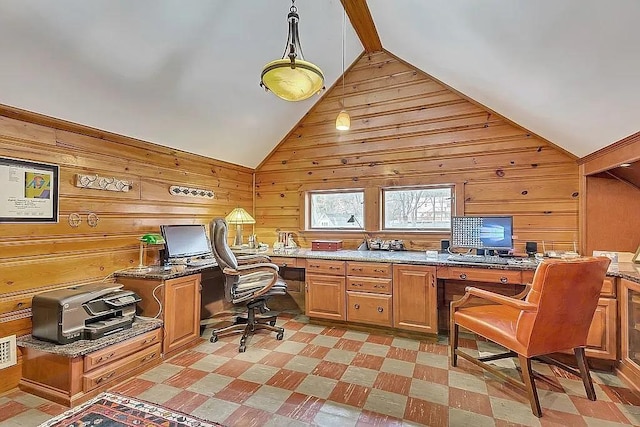 office space with built in desk, vaulted ceiling, and wooden walls