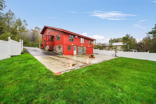 rear view of property with a yard