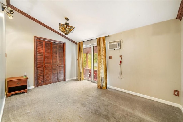 unfurnished bedroom featuring carpet flooring, a wall unit AC, crown molding, vaulted ceiling, and a closet