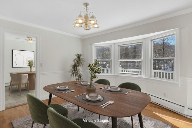 dining room featuring hardwood / wood-style flooring, crown molding, an inviting chandelier, and a baseboard heating unit