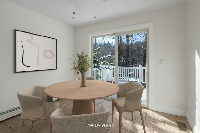 dining space with a baseboard radiator and ceiling fan