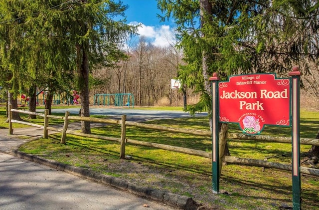 view of property's community featuring basketball court and a lawn