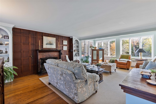 living room with built in features and a fireplace