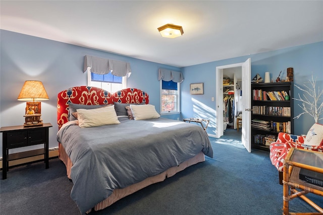 bedroom featuring dark colored carpet, a spacious closet, a baseboard radiator, and a closet