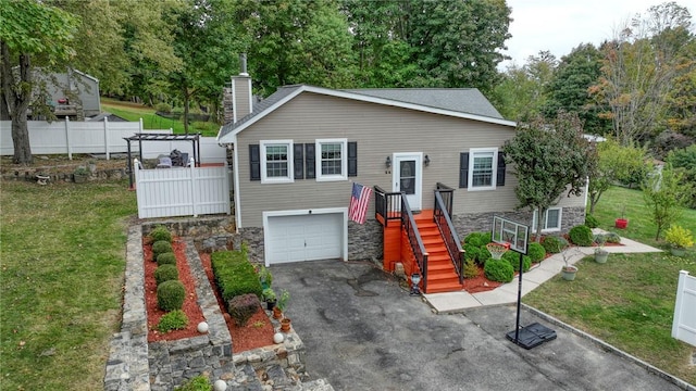 view of front facade with a garage and a front yard