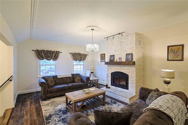 living room with a fireplace, dark hardwood / wood-style floors, an inviting chandelier, and lofted ceiling