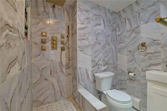 bathroom with a shower, vanity, tile walls, and toilet