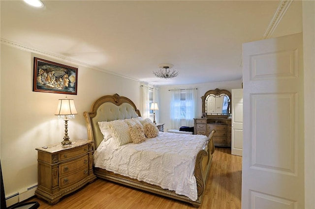 bedroom featuring a baseboard radiator, hardwood / wood-style flooring, and crown molding