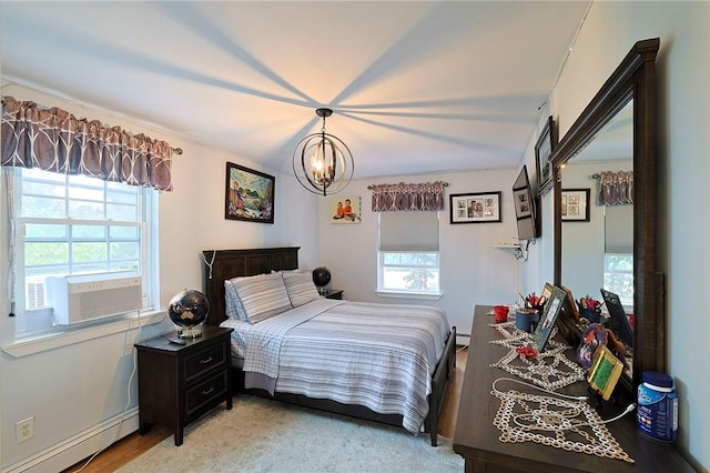 bedroom featuring cooling unit, an inviting chandelier, baseboard heating, and multiple windows