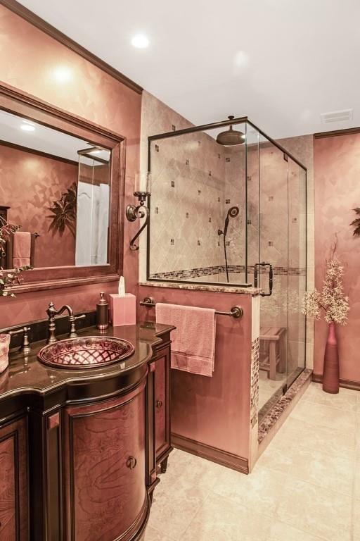 bathroom with vanity and a shower with shower door