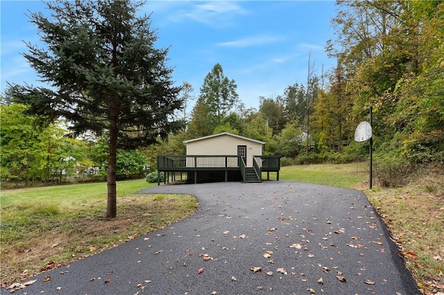 surrounding community featuring a lawn and a wooden deck