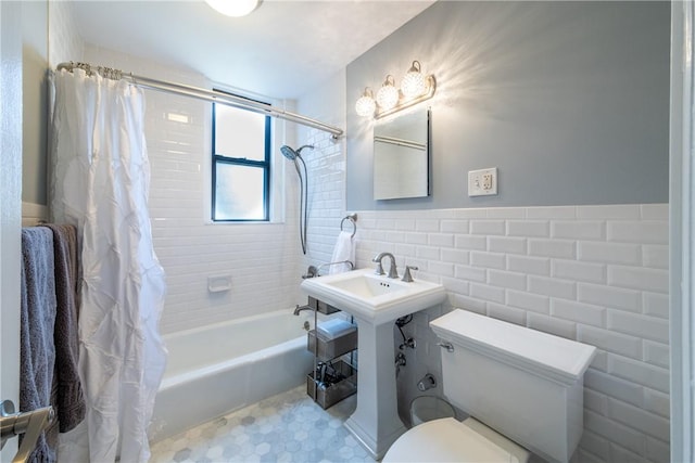 bathroom with shower / tub combo with curtain, tile walls, and toilet