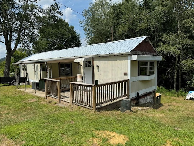 rear view of property with a lawn and covered porch