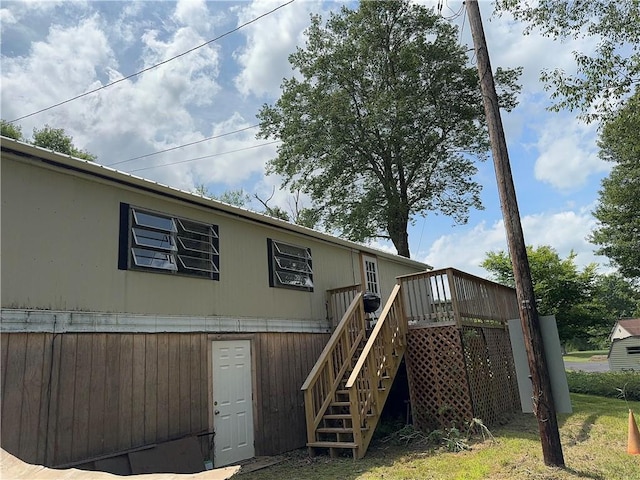 rear view of property featuring a wooden deck