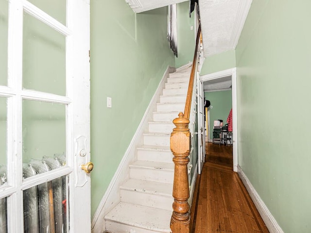 staircase with hardwood / wood-style flooring