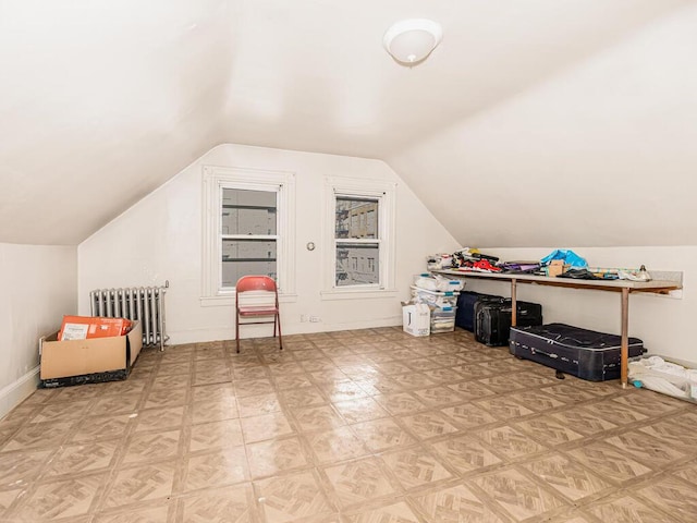 bonus room with lofted ceiling and radiator