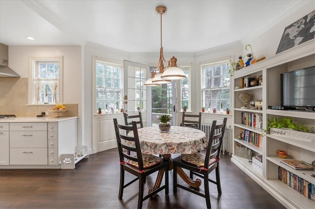 dining space with dark hardwood / wood-style flooring, french doors, and ornamental molding