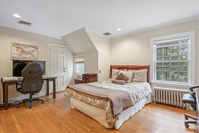 bedroom with wood-type flooring, ornamental molding, radiator, and multiple windows