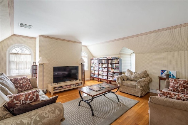 living room featuring light hardwood / wood-style flooring and vaulted ceiling